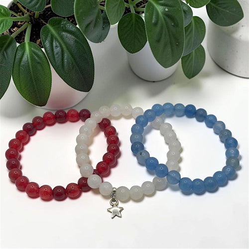 Crystals and Creations triple stretch bracelet set in red, white, and blue gemstone beads with a silver star charm.