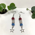 Crystals and Creations patriotic drop earrings with red, white, and blue beads, silver spacers, and star charms.