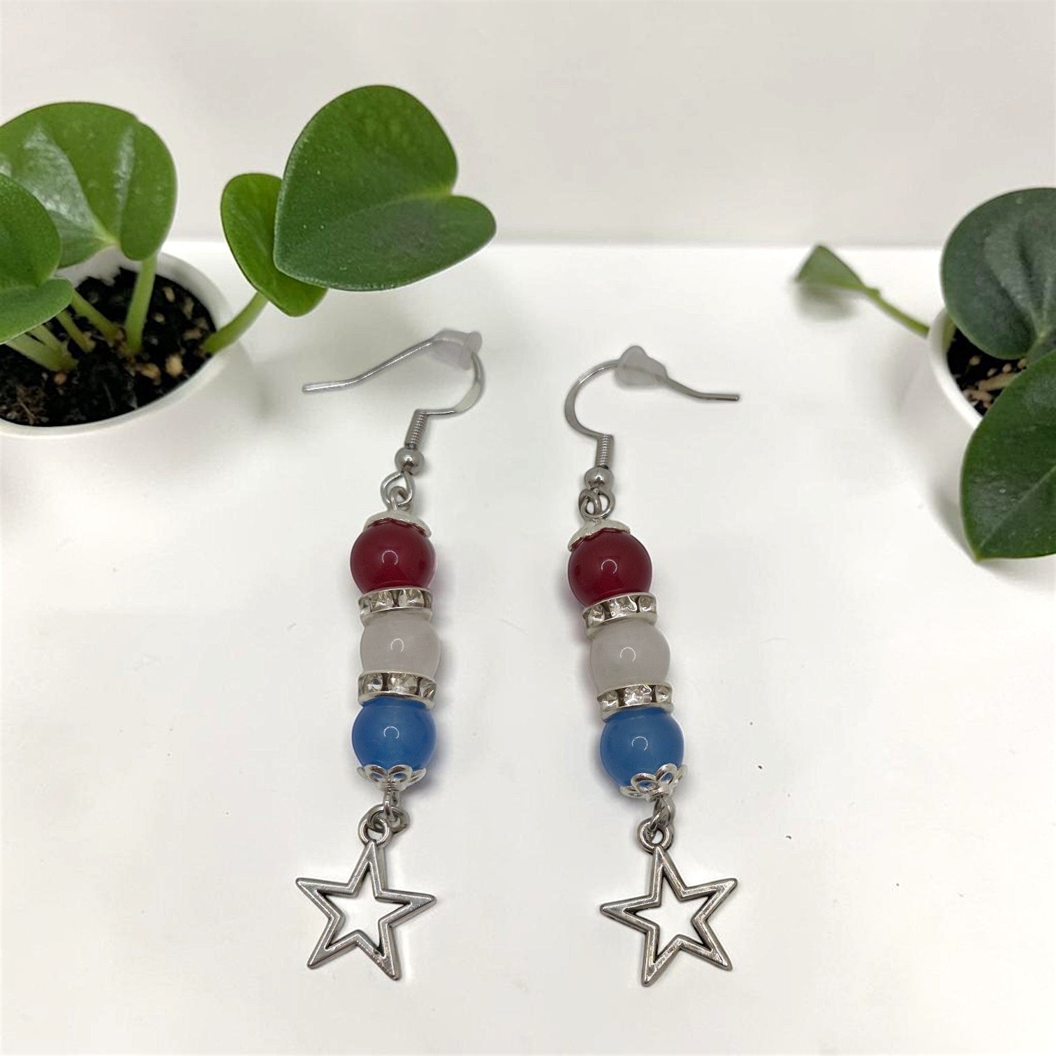 Crystals and Creations patriotic drop earrings with red, white, and blue beads, silver spacers, and star charms.