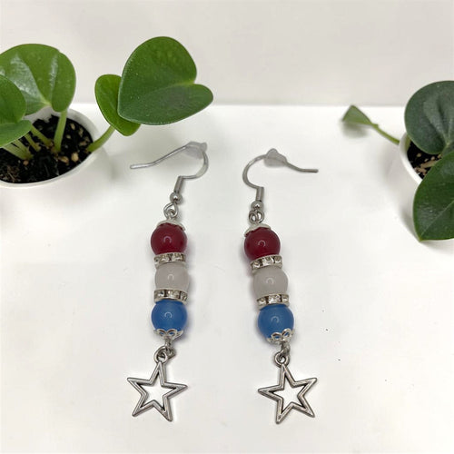 Crystals and Creations patriotic drop earrings with red, white, and blue beads, silver spacers, and star charms.